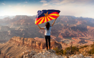 Woman with Arizona flag at the Grand Canyon